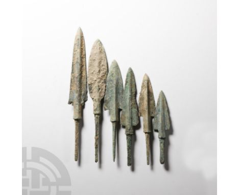 12th-10th century B.C. Comprising six tanged arrowheads, five with large elongated triangular blades and raised midrib, one w