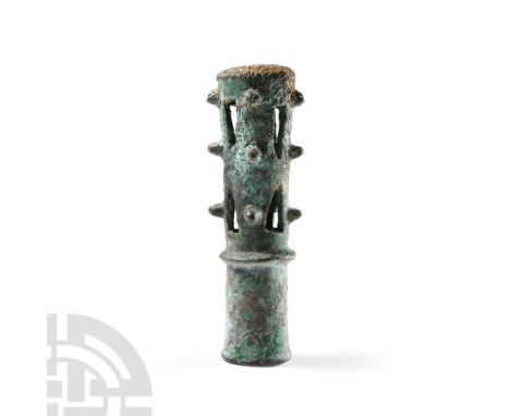 2600-2400 B.C. Cylindrical in shape, the upper section with alternating holes and vertical rows of three prominent spikes, sh