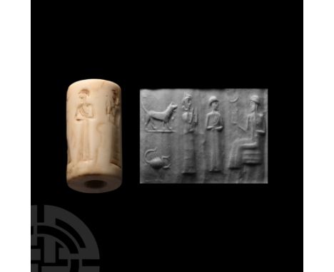 2nd-1st millennium B.C. With large central hole, incised frieze of a seated figure offering a cup to a figure in floor-length