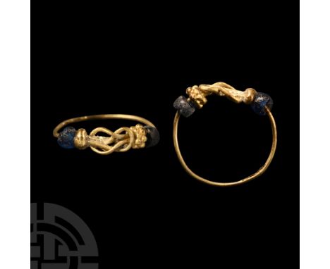1st century A.D. With slender wire shank formed into a knot for the bezel, blue glass seed beads to the shoulders and a gold 
