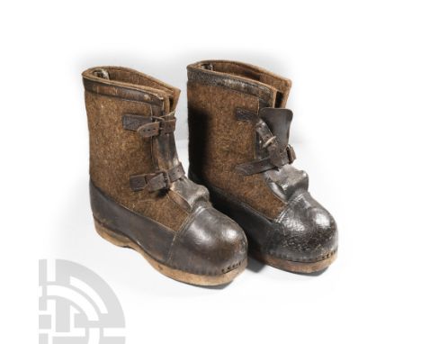 Circa 1940s A.D. The uppers of thick leather and a thick green-grey wool felt, leather mounts and hemming, iron buckles, wood