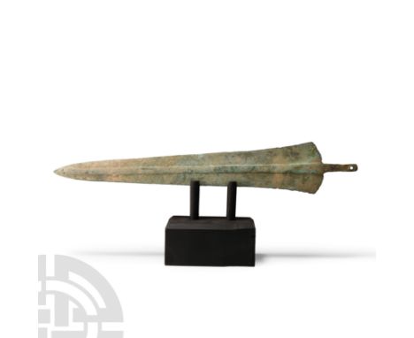 Early 1st millennium B.C. Triangular with thick rectangular-section midrib, rounded shoulders, narrow tip, short tang with ho