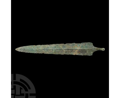 2nd-1st millennium B.C. With a short tang and long blade, raised midrib, a rivet to the base. See Negahban, E., Weapons from 