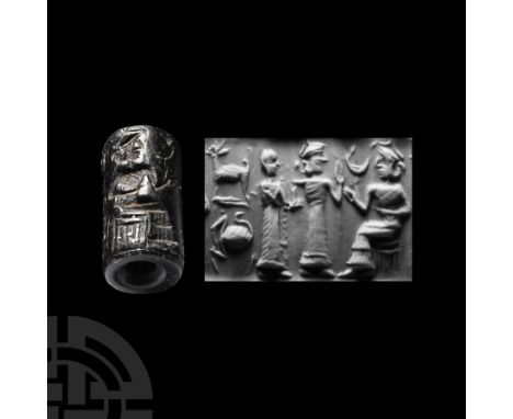 2nd-1st millennium B.C. With broad central piercing, frieze with seated king in a tiered robe facing two robed supplicants, s