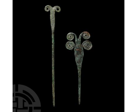 10th-6th century B.C. Comprising one with single spectacle head, and another with two pairs of spectacles forming the head.  