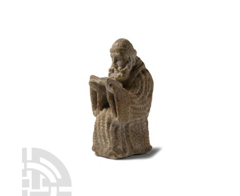 Western Europe, 17th-18th century A.D. Carved with semi-naturalistic facial features and a tonsured head, wearing a hooded cl