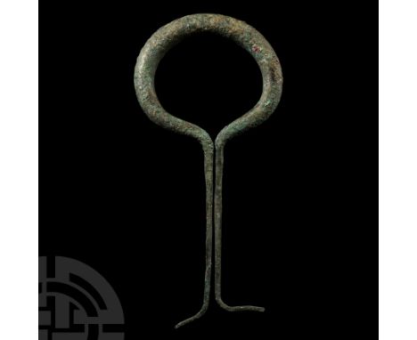 10th-6th century B.C. A heavy duty oval-shaped ring the ends tapering either side into fixing spikes.   354 grams, 21 cm (8 1