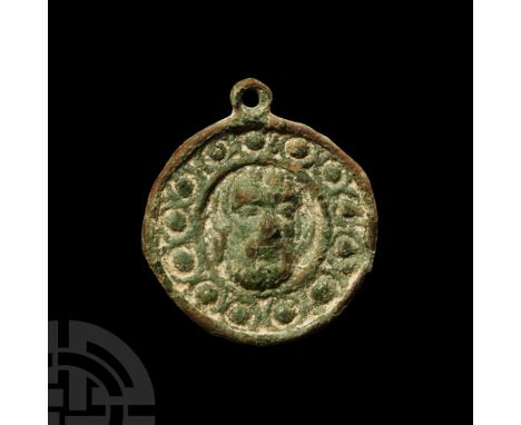 15th-16th century A.D. Discoid in form with suspension loop to apex, raised head of Saint John the Baptist at centre, framed 