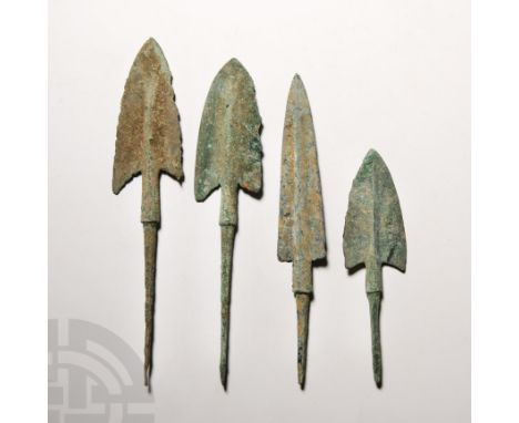 12th-10th century B.C. Comprising four tanged arrowheads, with large bronze elongated triangular blades and raised midrib, sh