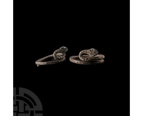 Roman Period, 30 B.C.-323 A.D. Of coiled circular form with crescent decorated body, the head with ring-and-dot eyes and v-sh