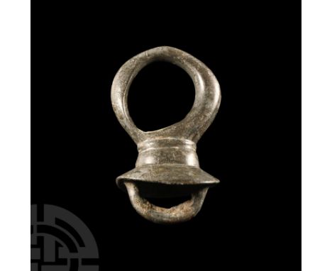 1st century B.C.-1st century A.D. Comprising a substantial ring mounted on a short neck with flared flange below and loop to 