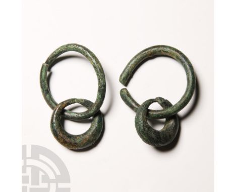 10th-6th century B.C. Comprising a pair of heavy crescent-shaped penannular rings each attached to a split ring.   84 grams t