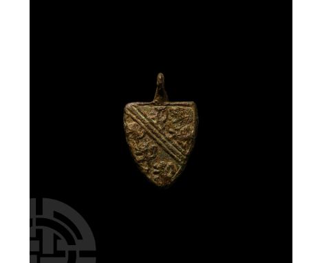 14th-15th century A.D. A heater-shield-shaped pendant with integral suspension loop; device: [azure] a bend argent, cotised a