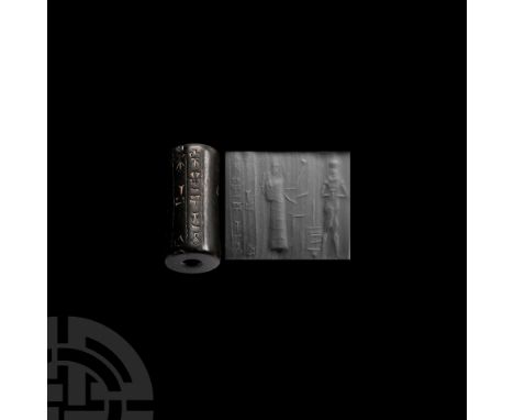 Circa 1894-1595 B.C. With large central hole, incised frieze of a standing nude hero facing and a figure in tiered floor-leng
