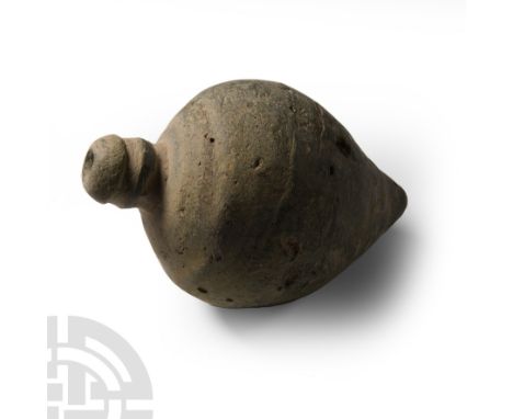 9th-11th century A.D. Piriform body with domed filler-hole, raised vertical flanges to the shoulder; intended to be filled wi