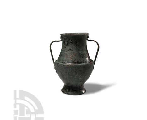 1st-2nd century A.D. With carinated profile to the shoulder and tapering neck, two riveted strap handles. Cf. similar item (w