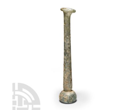 1st-3rd century A.D. A tall pale green iridescent bottle with bulbous flat bottomed base, tall neck and rolled everted rim. C