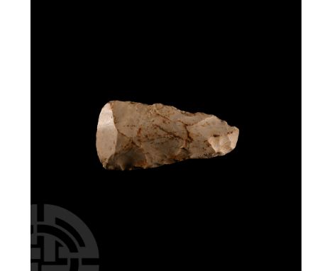Neolithic Period, 4th-3rd millennium B.C. Wedge-shaped in plan with convex cutting edge and butt, ridge to one cheek; handwri