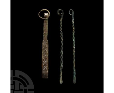 1st millennium B.C. Comprising two flat-ended spatulas with twisted shafts and loop finials, and a pair of tweezers with rect