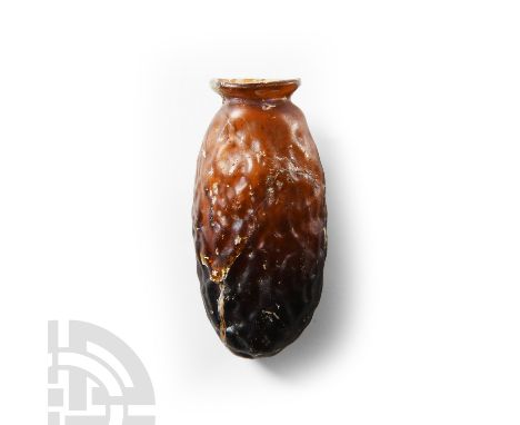 2nd-3rd century A.D. Mould-blown with elliptical body, short neck and thick everted rim in amber-tinted glass, the body with 
