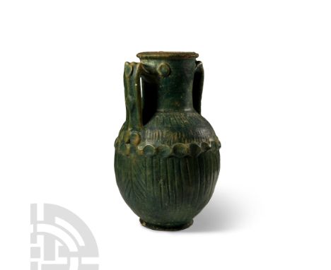 3rd century B.C.-2nd century A.D. With broad columnar neck and everted rim, angled strap handles, vertical ribbing to the sho