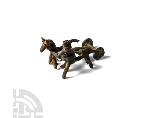 1st millennium B.C. Comprised two horse statuettes harnessed to a chariot or cart with thin sheet and wire.   42 grams, 67 mm