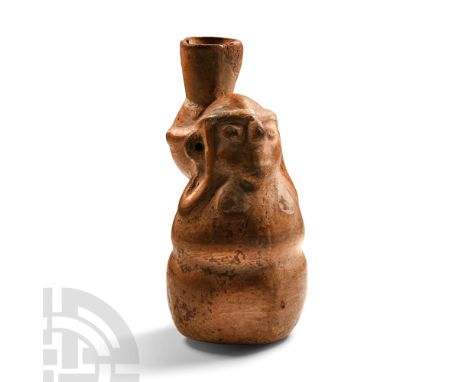 12th-15th century A.D. Formed as a squash-shaped female figure with pierced ears, a storage jar attached to her back with a b