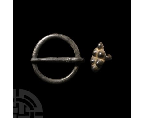 14th-15th century A.D. Comprising a heavy ring attached to a pin with hoop; and lozenge-shaped mount with six raised bosses a