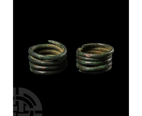 9th-11th century A.D. or earlier. Formed of tightly coiled round-section rods with tapering finials.   18.9 grams total, 21-2
