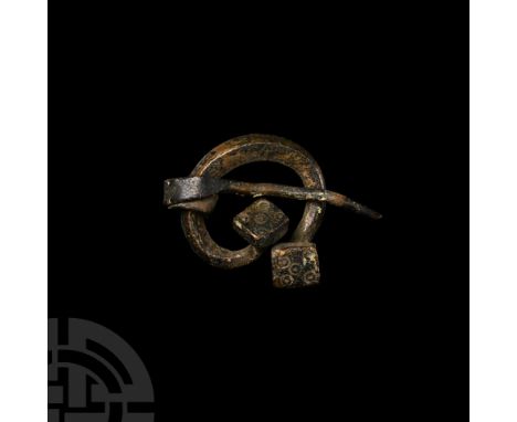 9th-11th century A.D. With square-headed terminals decorated with punched ring-and-dot motifs, free-running pin, brooch body 