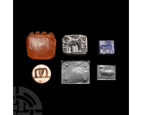 1st millennium B.C. Comprising: a pillow-shaped carnelian amulet pierced through the notched upper edge, hatched panels to bo