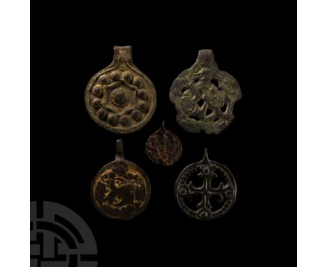 9th-11th century A.D. Comprising: disc with openwork cross cerecelé in a pelletted ring; gilded with regardant beast (surface
