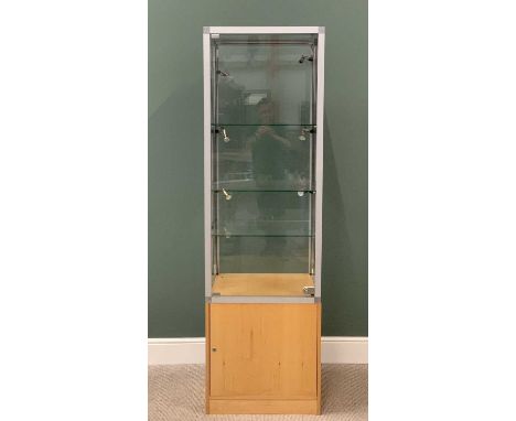 MODERN SQUARE COLUMN SHOP DISPLAY CABINET having a light wood base with single cupboard door under a single locking door glaz