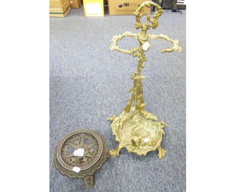 CAST BRASS STICK STAND, modelled with dog, gun and dead game, 23" high, and a CAST IRON CIRCULAR TRIVET, (2)