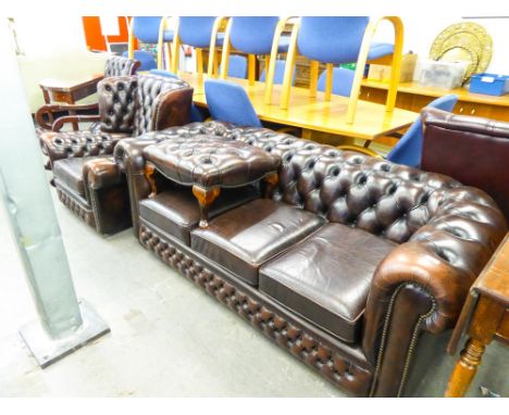 DARK BROWN HIDE, BUTTON UPHOLSTERED ROUND BACK CHESTERFIELD THREE SEATER SETTEE AND THE WINGED LOUNGE CHAIR AND FOOTSTOOL ENS