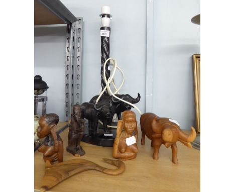 AFRICAN CARVED EBONY TABLE LAMP WITH TWO CARVED OXEN TO THE OVAL BASE, together with THREE CARVED WOOD FIGURES, CARVED OXEN a