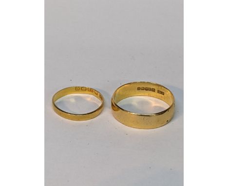 A 22ct yellow gold wide band ring, and a smaller 22ct yellow gold bandLocation: 