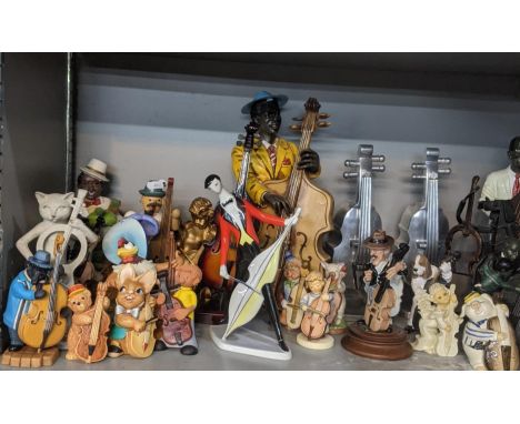 A collection of figurines and animals playing musical instruments to include Zsolnay porcelain figurine, jazz musician figuri