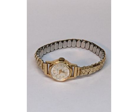 A ladies 18ct gold backed manual wind watch on an expanding braceletLocation: 