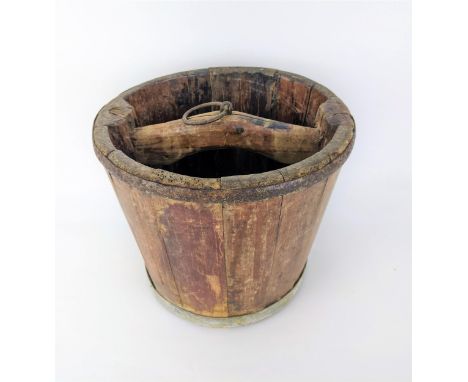A 19th century pine and metal coopered well bucket with a reinforced rim, and curved handle with a ring, 22cm high, 27cm diaA