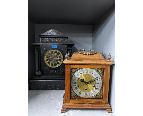 A Victorian black slate mantle clock of classical design with open pillars and frieze above the dial, gilt dial showing visib