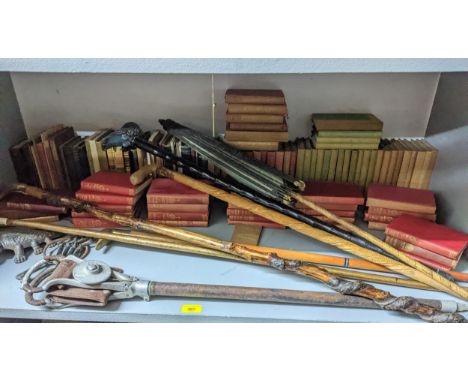 A mixed lot to include various books, walking canes, an Oriental/Asian parasol with bamboo shaft, leather and metal shooting 