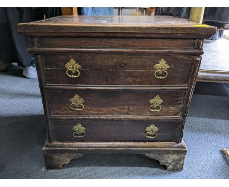 An early 18th century oak commode in the form of a three drawer chest of drawers, 49.5cm h x 49.5cm wLocation: 