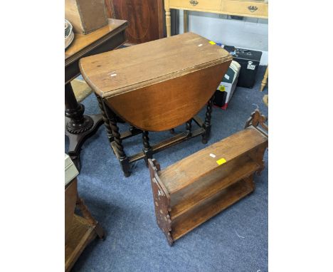 A 1930's oak gate leg table barley twist legs, 70cm h s 76cm w, together with an oak three tier wall shelfLocation: RAB 