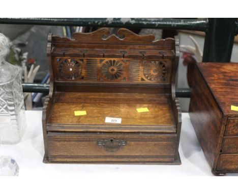 Early 20th century pipe rack with pierced metal back and small drawer 