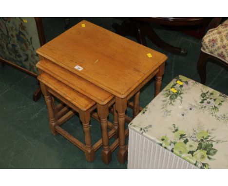 A nest of three light oak tables