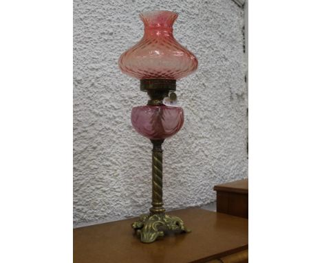 Antique oil lamp with red glass shade and reservoir, Hinks S.H.S. burner (small chip to shade) 