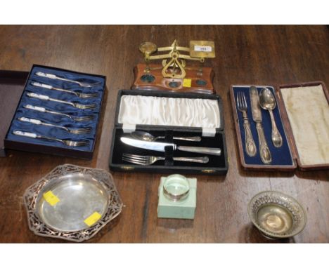 Set of postal scales, silver plated bowl, dish and napkin ring, 2 cased sets of knife, fork and spoon and a set of 6 cake for