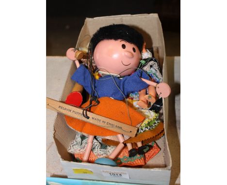 A Pelham puppet and nine small dolls.