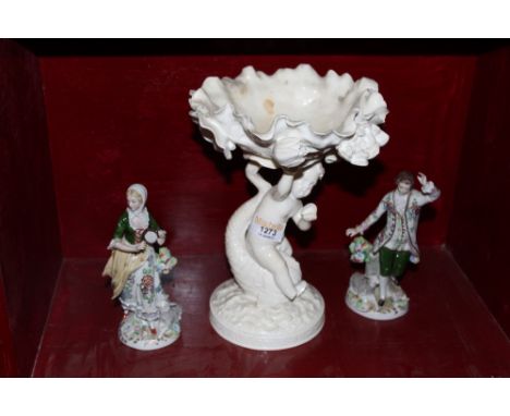 A Victorian Moore white glazed pottery tazza, modelled as a putti, a strider dolphin supporting floral encrusted bowl, 26 cm 